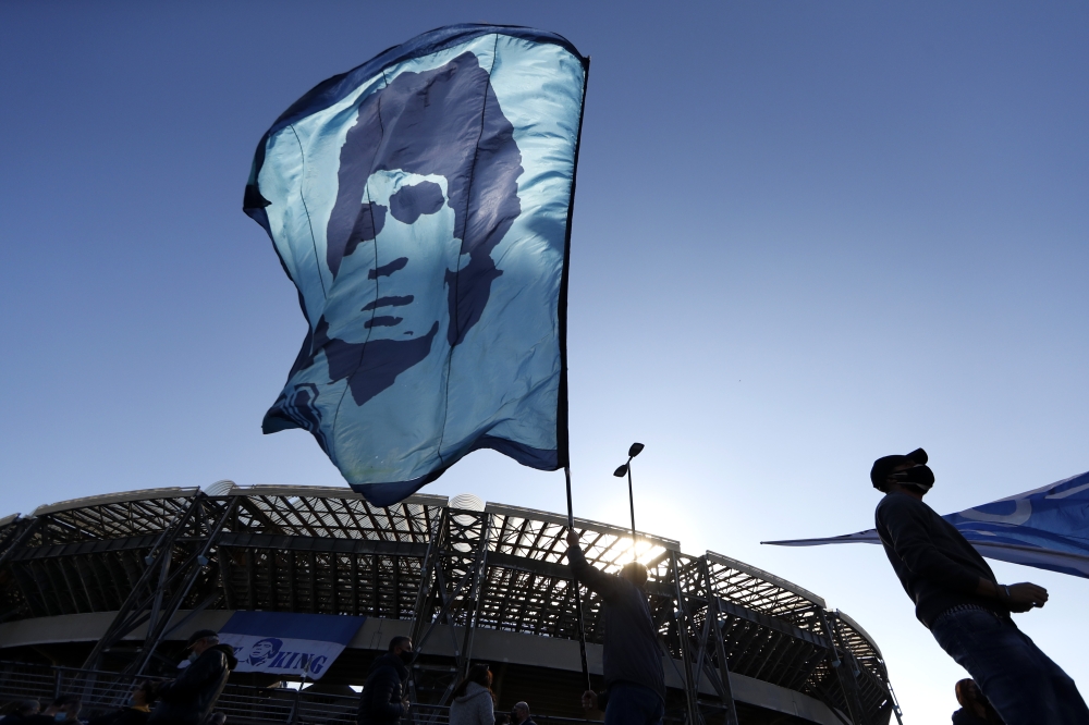 A person waves a Diego Maradona flag outside the Stadio San Paolo REUTERS/Yara Nardi