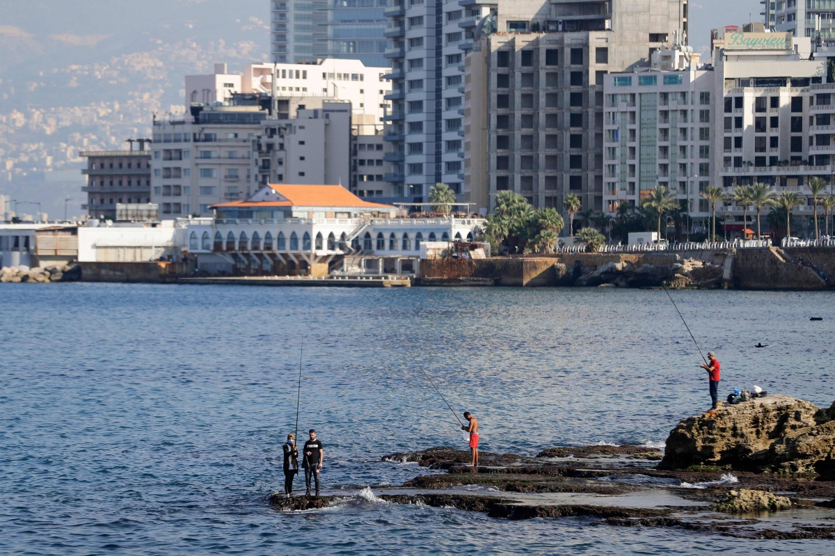 Lebanese fishermen are pictured near the promenade in the capital Beirut on November 24, 2020. / AFP / JOSEPH EID
