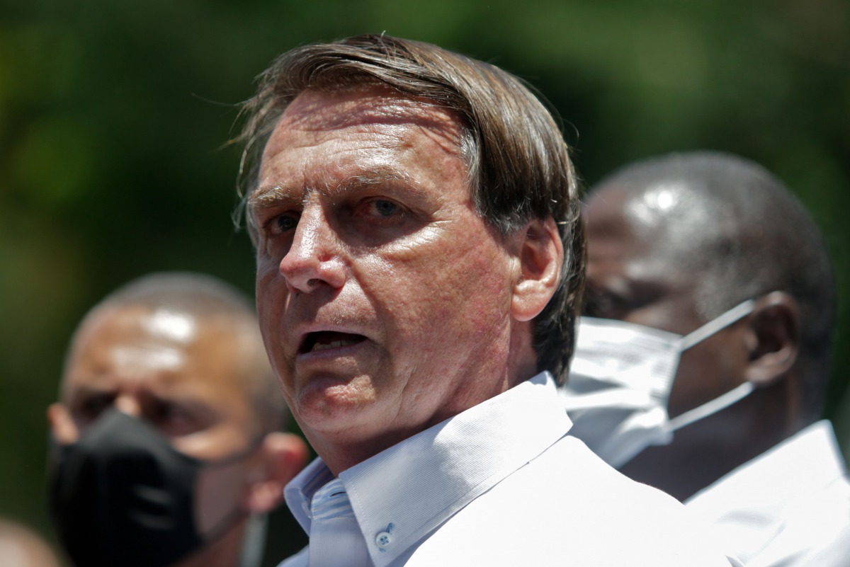 Brazilian President Jair Bolsonaro speaks to the press after voting during the second round of municipal elections at the Rosa da Fonseca Municipal School, in the Military Village, Rio de Janeiro, Brazil, on November 29, 2020. / AFP / Andre Coelho
