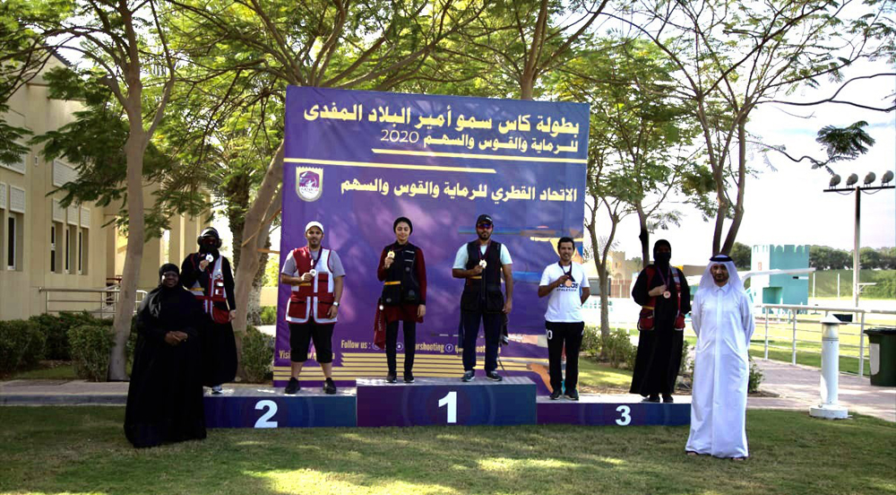 Shooters and officials pose for a group photo after medal ceremony of mixed skeet team event.
