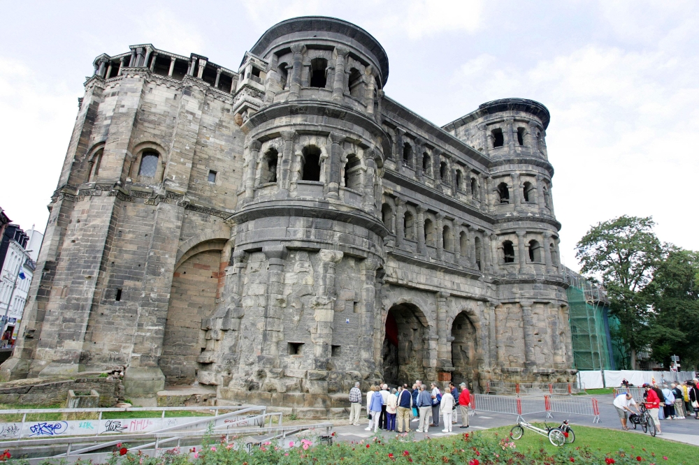File Photo: Tourist in front of Trier's most famous monument, the Porta Nigra, or Black Gate.  AFP / John MACDOUGALL
