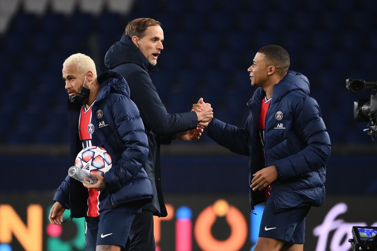 Paris Saint-Germain's French forward Kylian Mbappe (R), Paris Saint-Germain's German coach Thomas Tuchel (C) and Paris Saint-Germain's Brazilian forward Neymar (L) celebrate after winning the UEFA Champions League Group H second-leg football match between