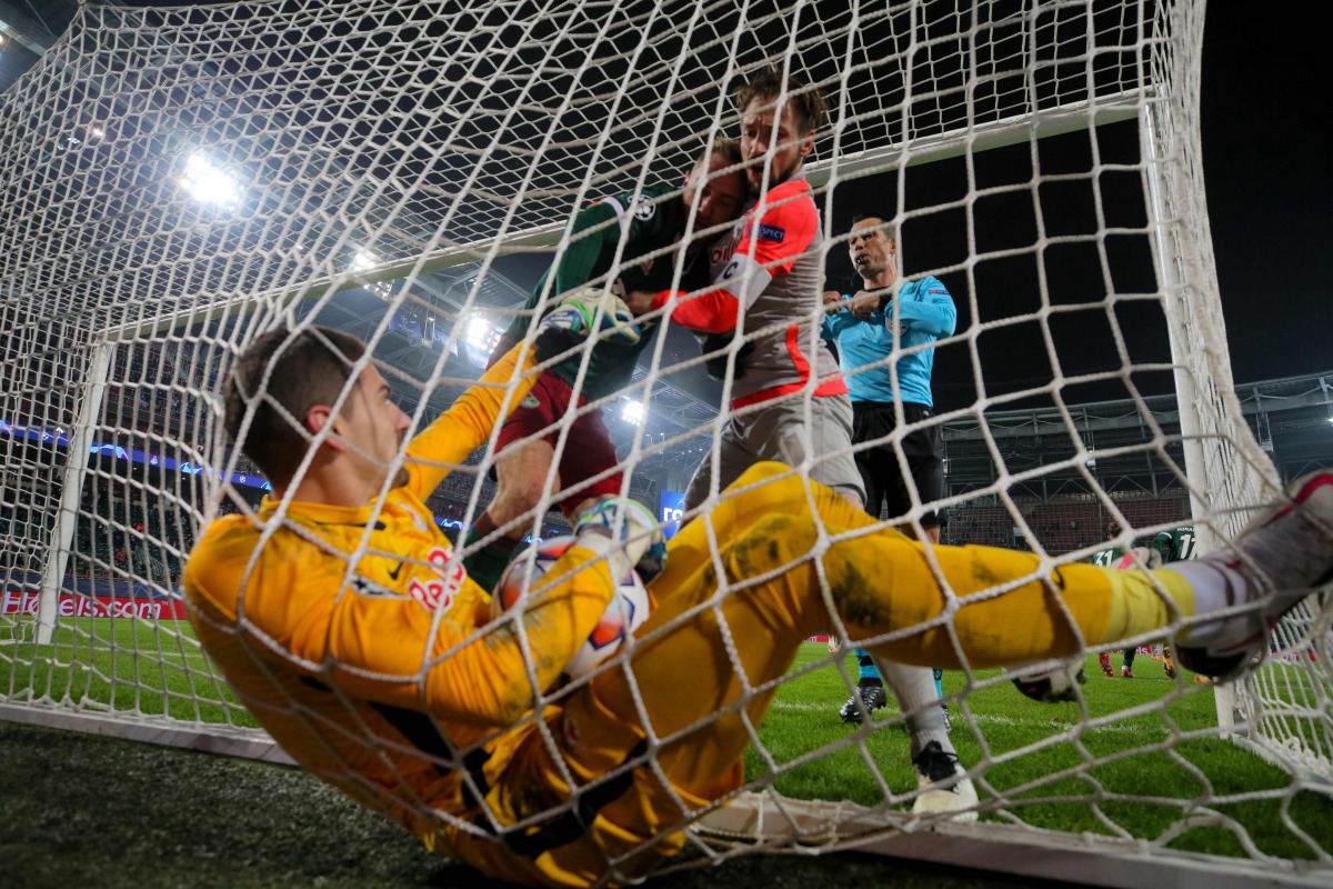 Salzburg's Austrian goalkeeper Cican Stankovic holds the ball after Lokomotiv Moscow's Russian midfielder Anton Miranchuk scored the team's first goal from the penalty spot during the UEFA Champions League football match between Lokomotiv Moscow and Salzb