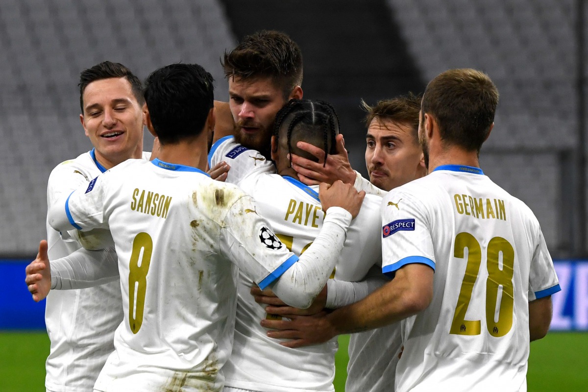 Marseille's French forward Dimitri PAYET (C) is congratulated by teammates after scoring a goal during the UEFA Champions League Group C football match between Olympique de Marseille (OM) and Olympiakos at the Velodrome stadium in Marseille on December 1,