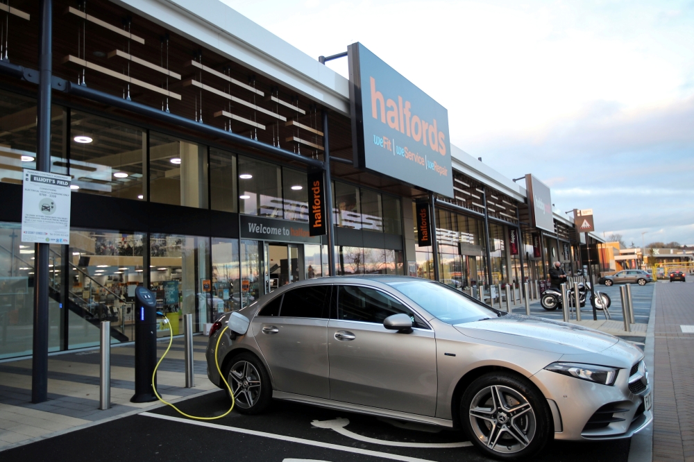File photo: An electric car is seen at a charging point at Halfords in Rugby, Britain, November 19, 2020. REUTERS/Molly Darlington/File Photo