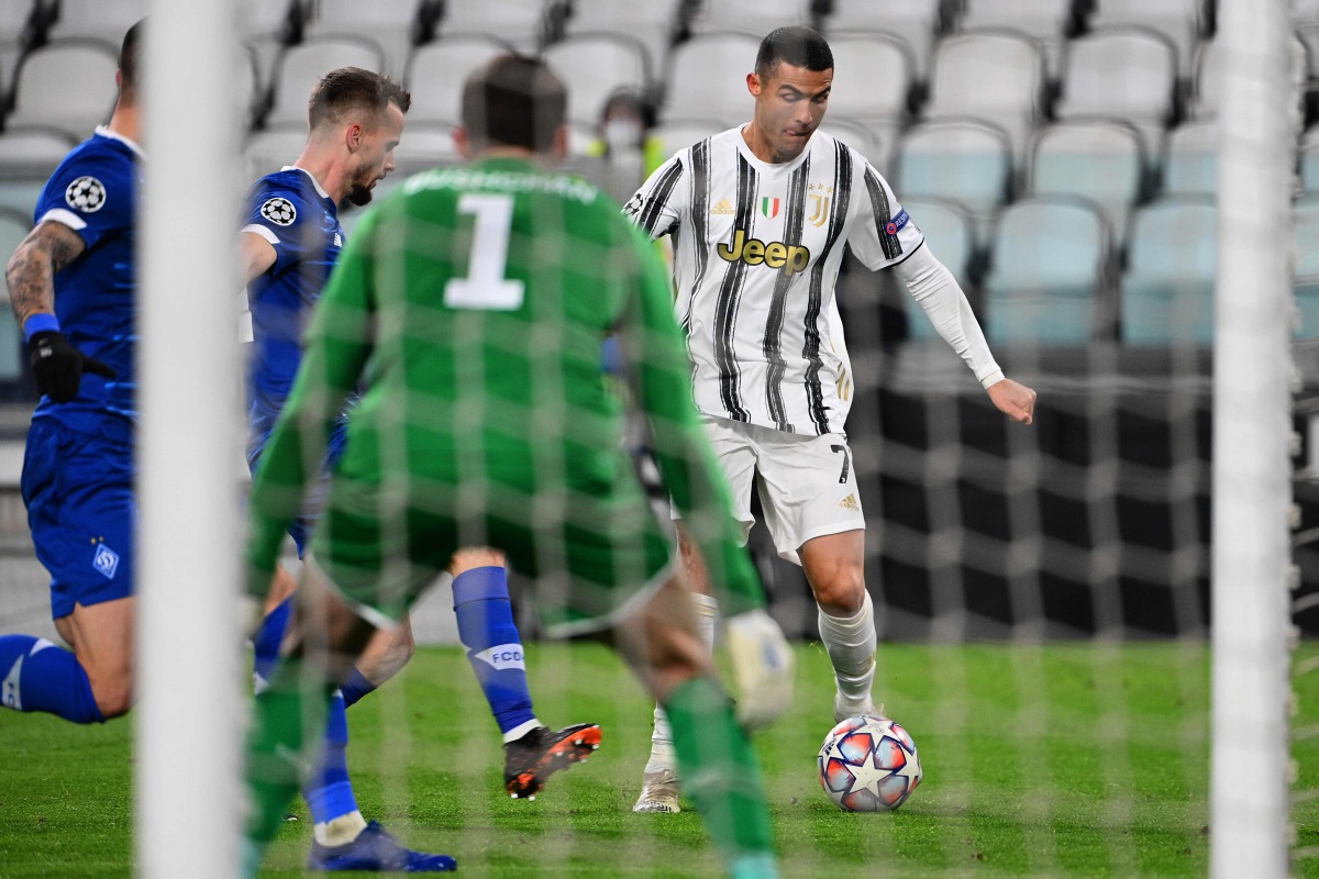 Juventus' Portuguese forward Cristiano Ronaldo (R) outruns Dynamo Kiev's Polish defender Tomasz Kedziora (L) and Dynamo Kiev's Ukrainian defender Denys Popov during the UEFA Champions League Group G football match Juventus vs Dynamo Kiev on December 2, 20