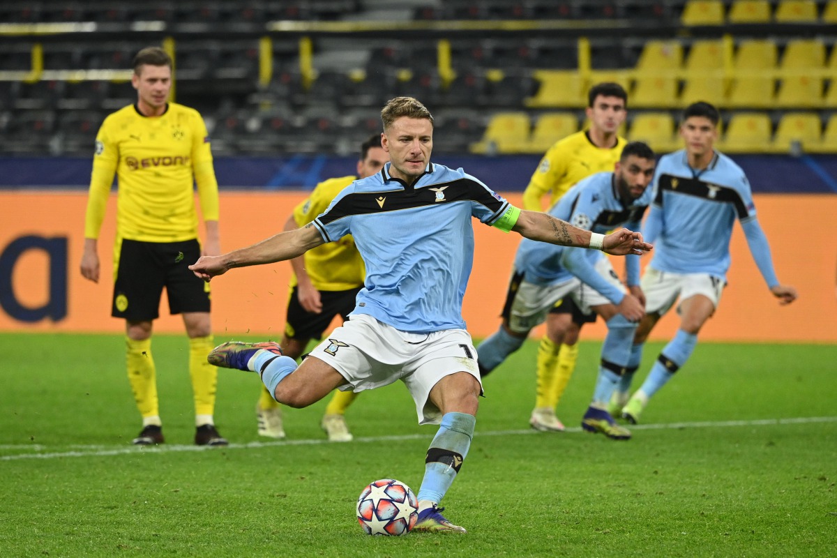 Lazio's Italian forward Ciro Immobile scores a penalty during the UEFA Champions League group F football match BVB Borussia Dortmund v Lazio in Dortmund, western Germany, on December 2, 2020. / AFP / Ina Fassbender
