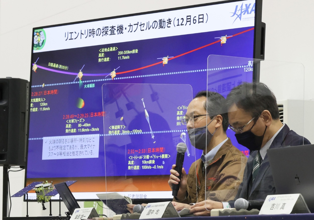 Yuichi Tsuda (L), Hayabusa2 project manager of the Japan Aerospace Exploration Agency (JAXA), answers questions at a press conference held before the return of the sample capsule of the Hayabusa 2 probe to the earth at JAXA Sagamihara Campus in Sagamihara