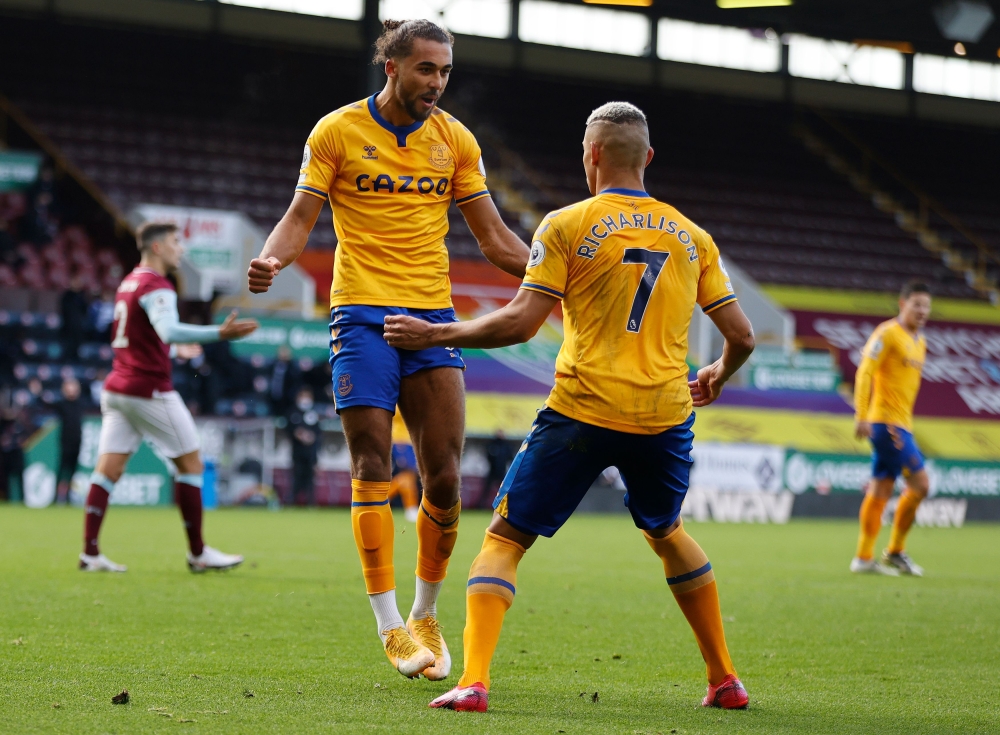 Everton's English striker Dominic Calvert-Lewin (L) celebrates after scoring the equalizing goal during the English Premier League football match between Burnley and Everton at Turf Moor in Burnley, north west England on December 5, 2020.  AFP / Clive Bru