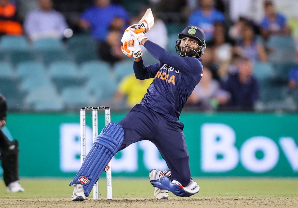 India's Ravindra Jadeja hits a boundary during the T20 cricket match between India and Australia at Manuka Oval in Canberra on December 4, 2020. (AFP / DAVID GRAY)