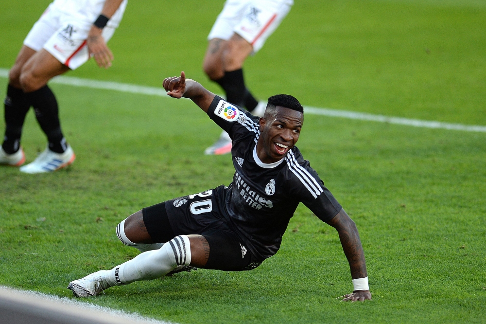 Real Madrid's Brazilian forward Vinicius Junior celebrates after scoring a goal during the Spanish League football match between Sevilla and Real Madrid at the Sanchez Pizjuan stadium in Seville on December 5, 2020. / AFP / CRISTINA QUICLER
