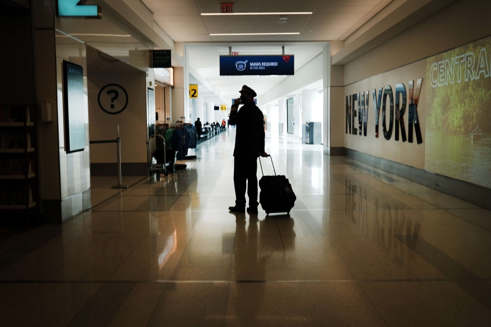 A pilot moves through New York's LaGuardia Airport on December 03, 2020 in New York City. Spencer Platt/AFP