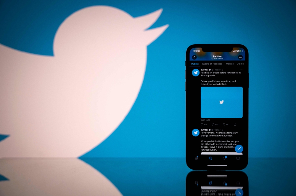 (FILES) In this file photo taken on October 26, 2020 this photograph shows the logo of US social network Twitter displayed on the screen of a smartphone and a tablet in Toulouse, southern France. / AFP / Lionel BONAVENTURE
