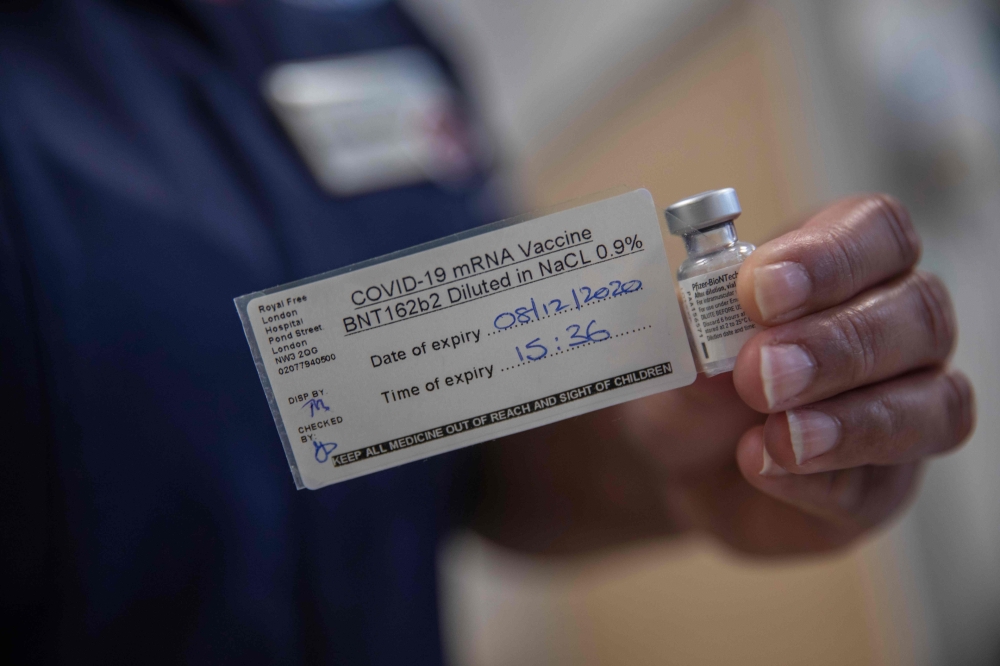 A nurse holds a phial of the Pfizer-BioNTech Covid-19 vaccine at the Royal Free hospital in London on December 8, 2020 at the start of the UK's biggest ever vaccination programme.   AFP / POOL / Jack Hill