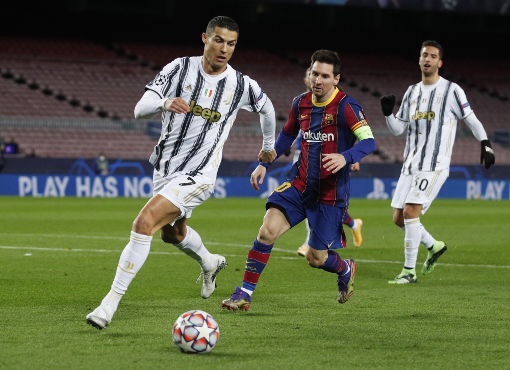 FC Barcelona's Lionel Messi in action with Juventus' Cristiano Ronaldo. Reuters/Albert Gea