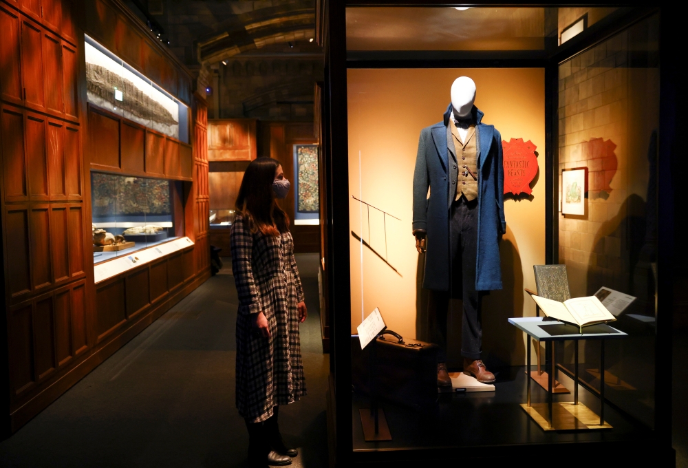 A museum employee poses for media next to Newt Scamander's costume, part of the 'Fantastic Beasts: The Wonder of Nature' exhibition opening soon at the Natural History Museum in London, Britain, December 8, 2020. Picture taken December 8, 2020. REUTERS/He