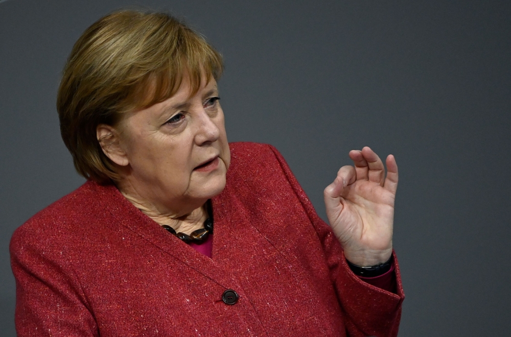 German Chancellor Angela Merkel gestures as she speaks during a debate at the Bundestag (lower house of parliament) in Berlin on December 9, 2020, on the eve of an EU summit. AFP / Tobias Schwarz 