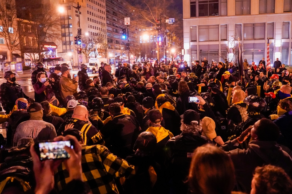 Members of the far-right group Proud Boys kneel as they gather near Black Lives Matter Plaza in Washington, U.S., December 12, 2020. Reuters/Erin Scott
 