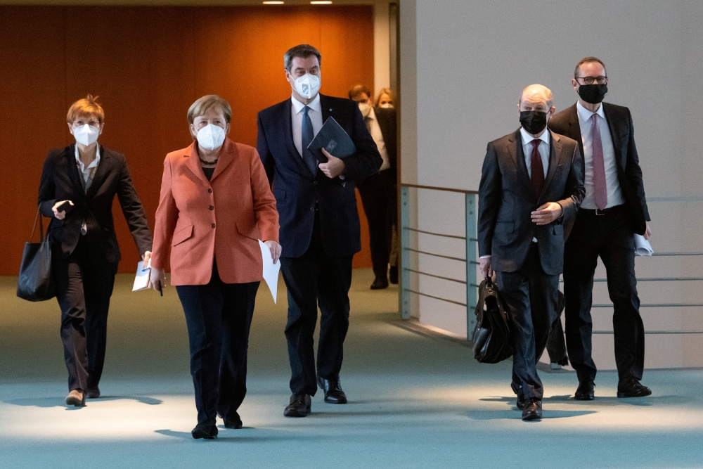 German Chancellor Angela Merkel, Bavarian State Premier Markus Soeder, German Finance Minister Olaf Scholz and Berlin Mayor Michael Mueller arrive for a news conference following talks with state leaders to discuss anti-coronavirus measures at the Chancel