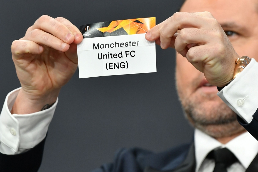 Portuguese football player Nuno Ricardo de Oliveira Ribeiro aka Maniche revealing the slip of Manchester United during the draw for the round of 32 of the UEFA Europa League. AFP