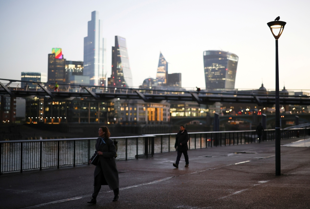 The financial district can be seen as a people walk along the South bank, amid the coronavirus disease (COVID-19) outbreak, in London, Britain, December 14, 2020. REUTERS/Henry Nicholls