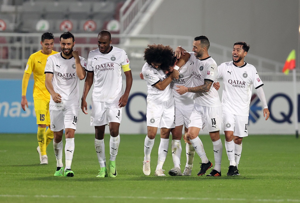 Al Sadd players celebrate during their match against Al Gharafa.