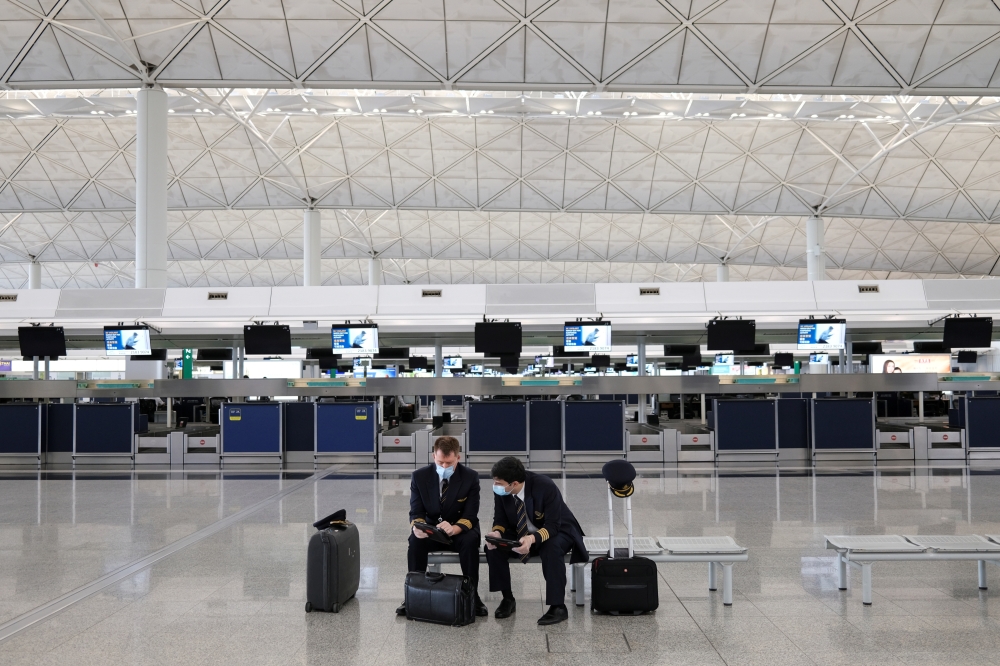 Pilots wearing face masks to avoid the spread of the coronavirus are seen at the Hong Kong International Airport, in Hong Kong, China May 7, 2020. Picture taken May 7, 2020. REUTERS/Tyrone Siu/File Photo