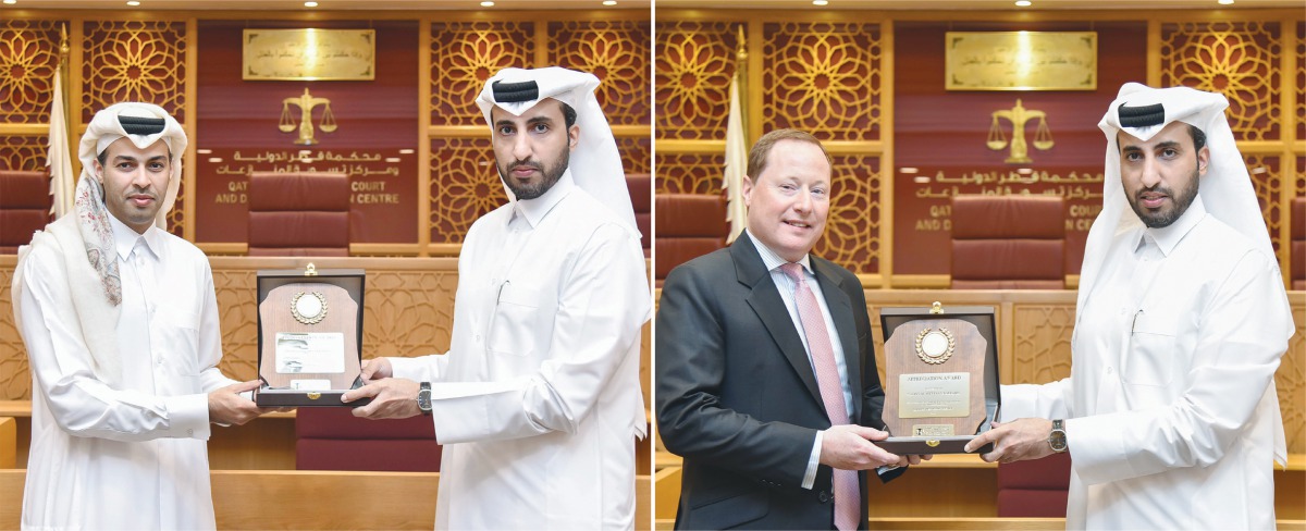 Faisal Al Sahouti, CEO of the Qatar International Court, presenting the awards to the officials of Omani & Partners Law Firm LLP and Sultan Al-Abdulla & Partners.