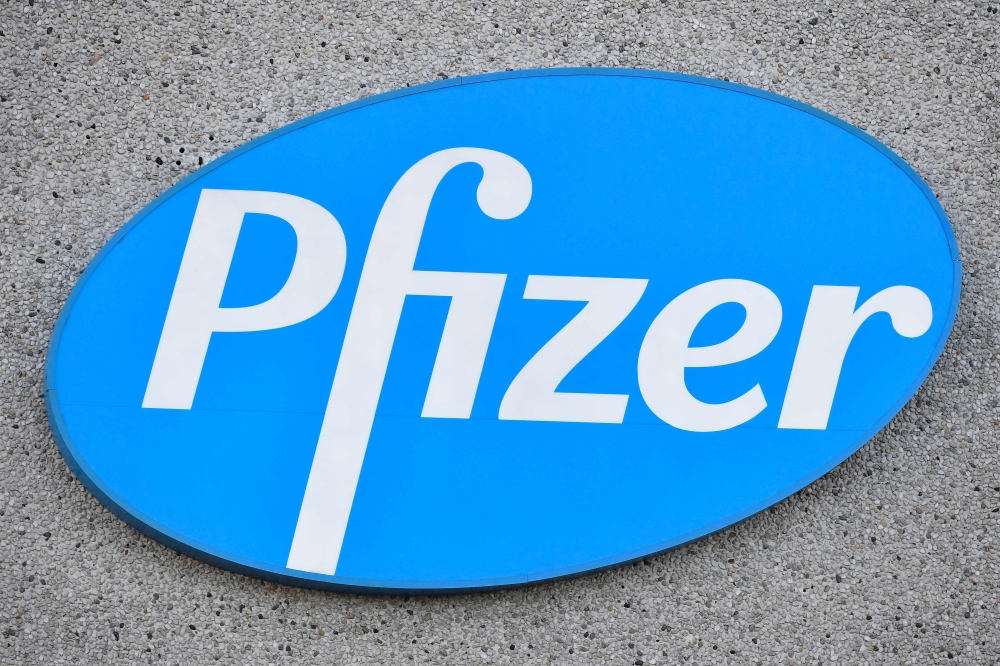 This photograph taken on December 22, 2020 in Puurs shows the logo of US multinational pharmaceutical company Pfizer at the production site of the Covid-19 vaccine that was given the European Union's green light the day before, paving the way for vaccinat