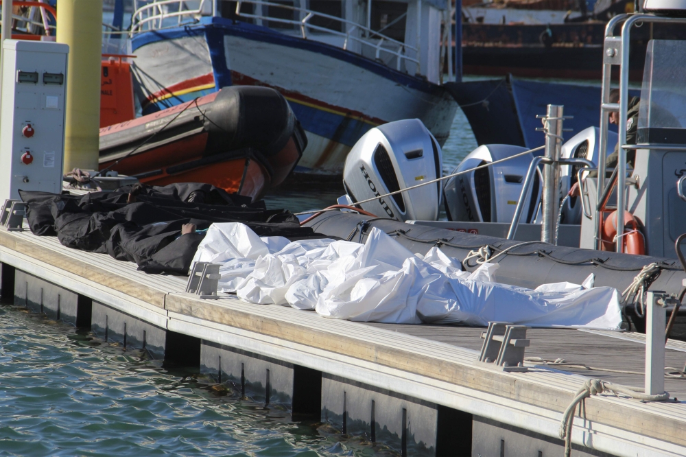 A picture taken at the port of Sfax in central Tunisia show the recovered bodies of 20 migrants from sub-Saharan Africa after their boat capsized at sea, on December 24, 2020. (AFP / HOUSSEM ZOUARI)