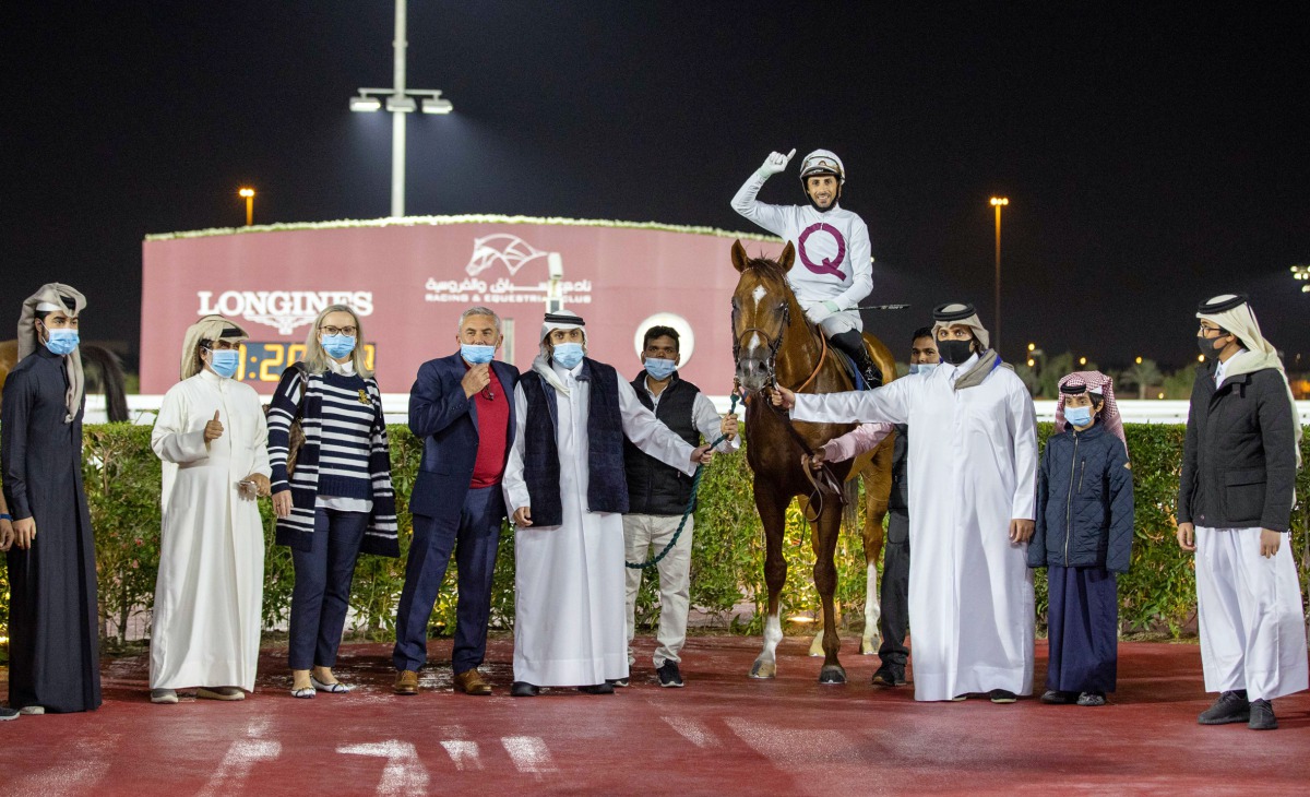 H H Sheikh Mohammed bin Khalifa Al Thani presenting the winner's trophy to representatives of Al Wasmiyah Farm after Noor Al Hawa (FR) won the Gr2 Trophy race for 3YO+ Thoroughbreds yesterday. 