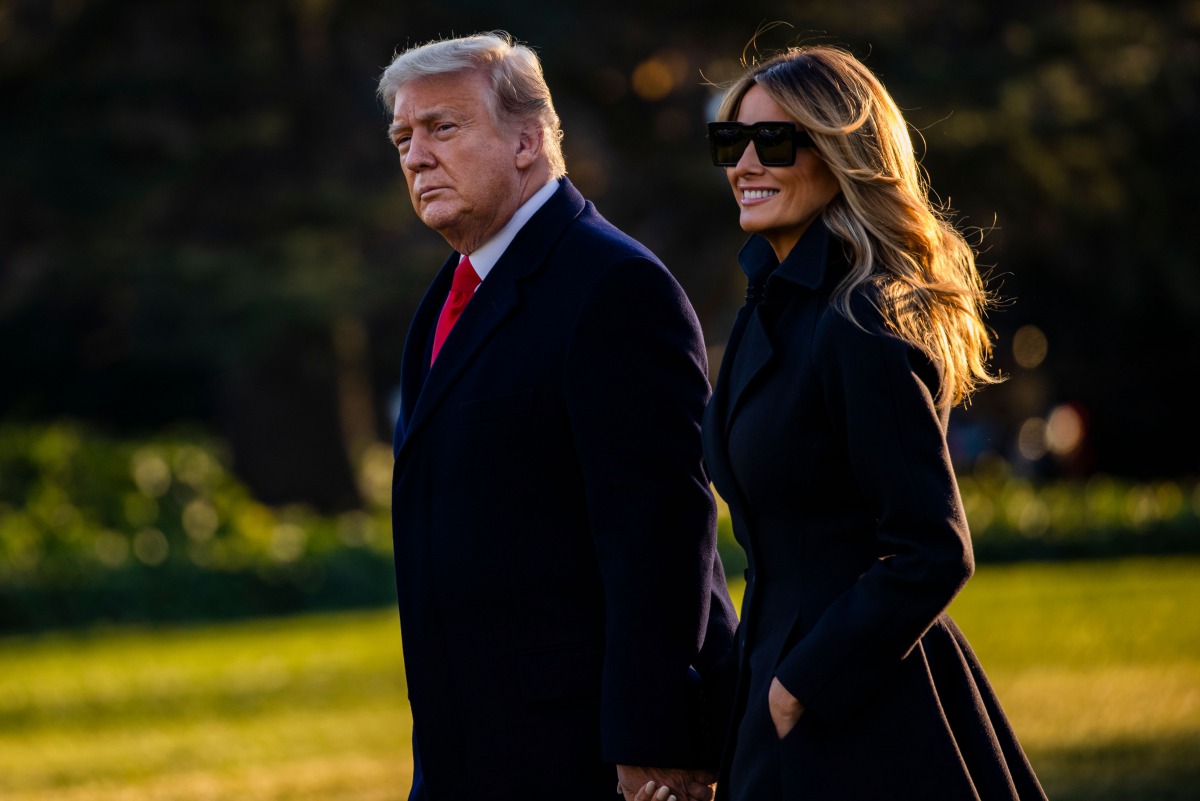 President Donald Trump and First Lady Melania Trump walk towards Marine One as they depart the White House en route to Mar-a-Lago, the President's private club, where they will spend Christmas and New Years Eve in Washington, DC on December 23, 2020./ AFP