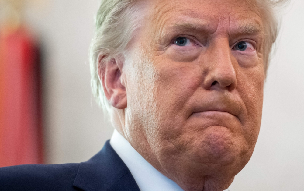 In this file photo taken on December 07, 2020, US President Donald Trump looks on during a ceremony presenting the Presidential Medal of Freedom to wrestler Dan Gable in the Oval Office of the White House in Washington, DC. AFP / Saul Loeb 