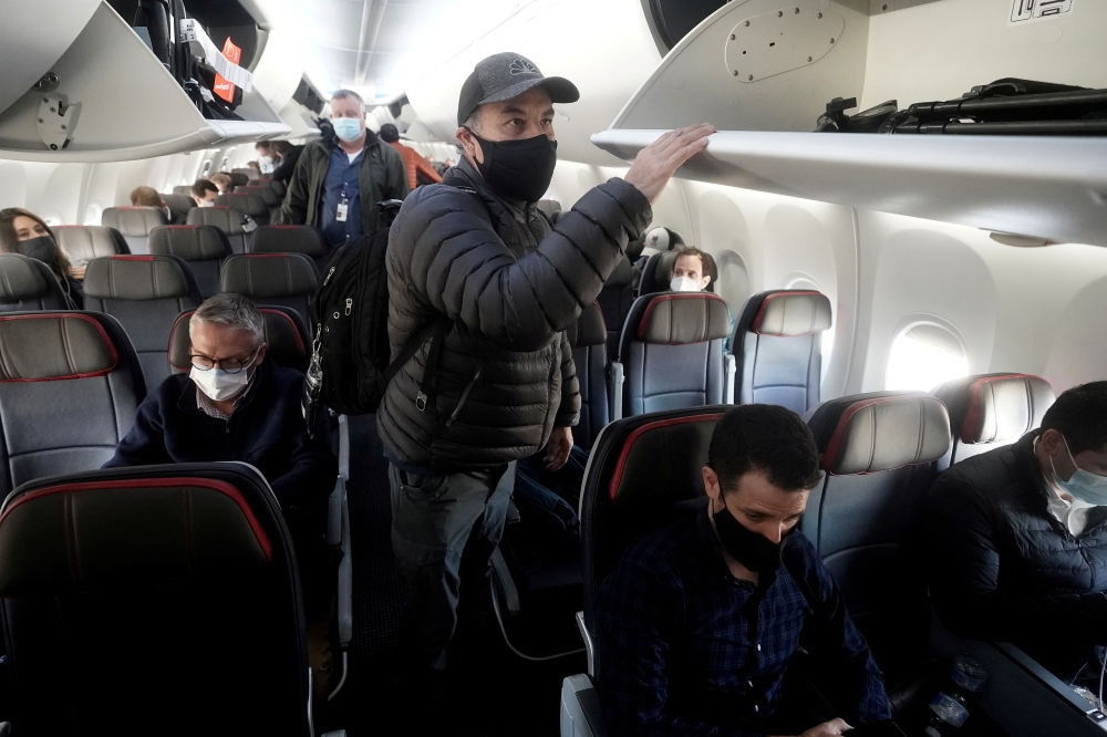 FILE PHOTO: People depart a Boeing 737 Max airplane at Dallas Fort Worth Airport following a media flight to Tulsa, Oklahoma, in Dallas, Texas, U.S., December 2, 2020. REUTERS/Carlo Allegri