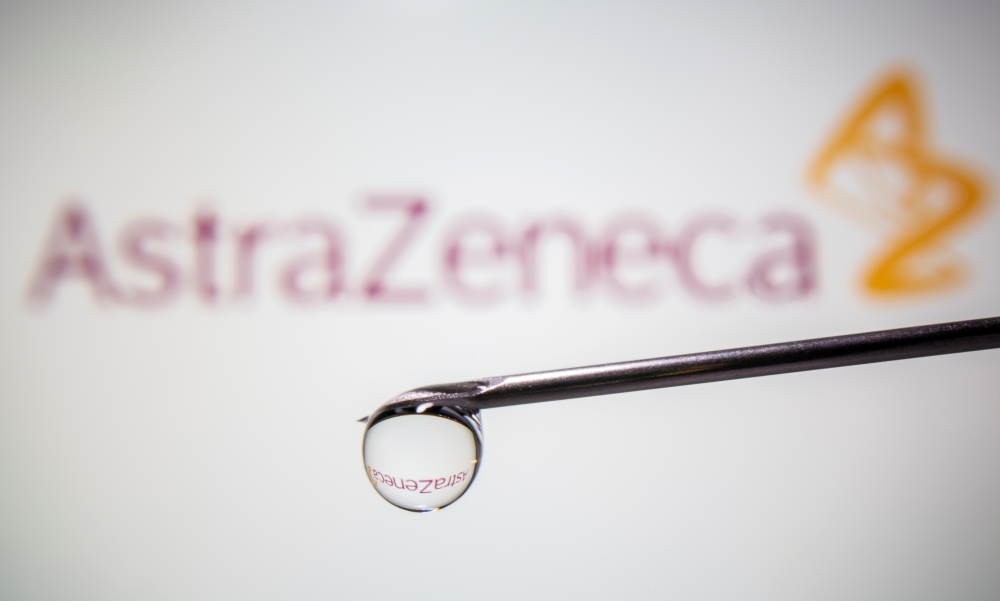 AstraZeneca's logo is reflected in a drop on a syringe needle in this illustration taken November 9, 2020. REUTERS/Dado Ruvic/Illustration/File Photo
