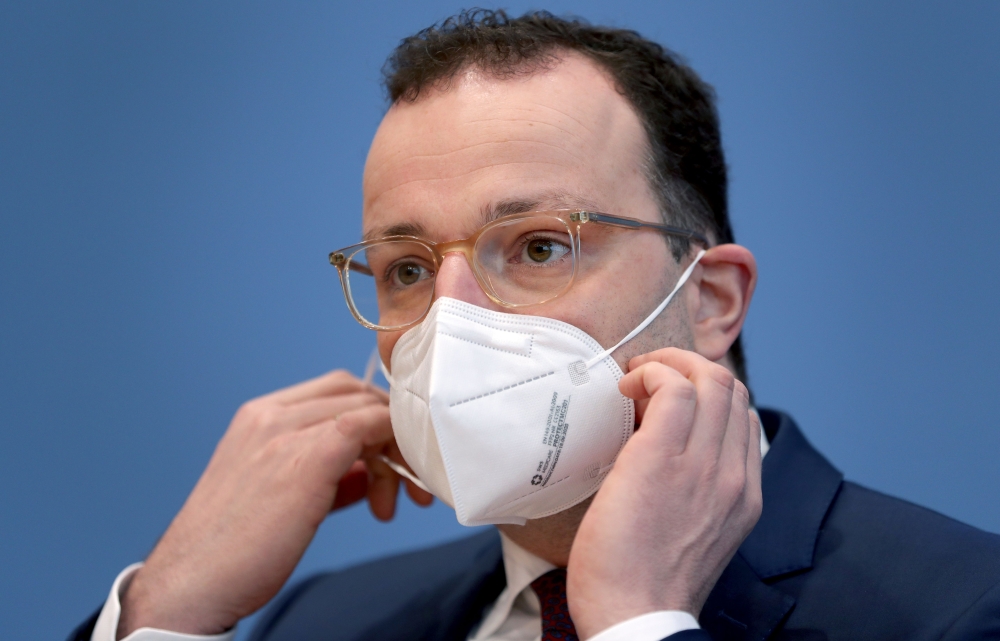 German Health Minister Jens Spahn wears a face mask as he arrives for a press conference in Berlin, Germany, on December 30, 2020, to comment on the current situation amid the new coronavirus, COVID-19 pandemic and the vaccination campaign in Germany. / A