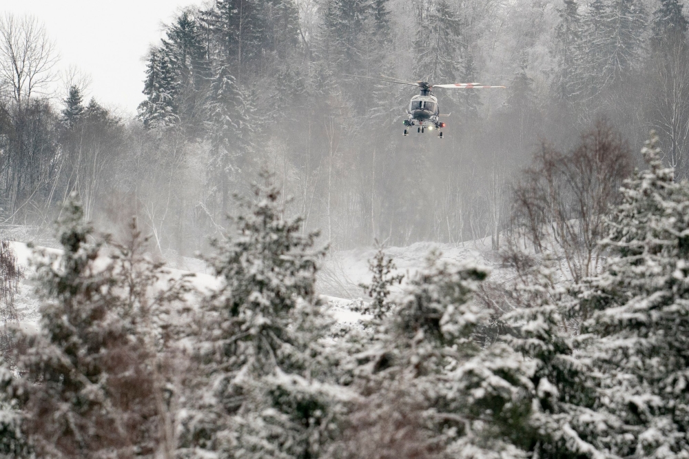 A helicopter flies over Ask in Gjerdrum municipality on December 31, 2020, one day after a major landslide and clay landslide. A major landslide destroyed homes overnight to December 30, 2020 in the village of Ask in Norway close to the capital Oslo, leav