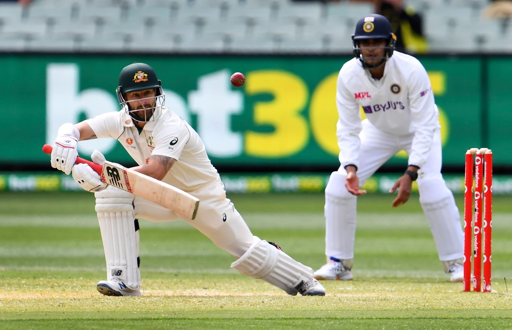 Australia's Matthew Wade (L) plays a shot as India's Shubman Gill looks on during the third day of the second cricket Test match between Australia and India at the MCG in Melbourne on December 28, 2020. AFP / WILLIAM WEST /