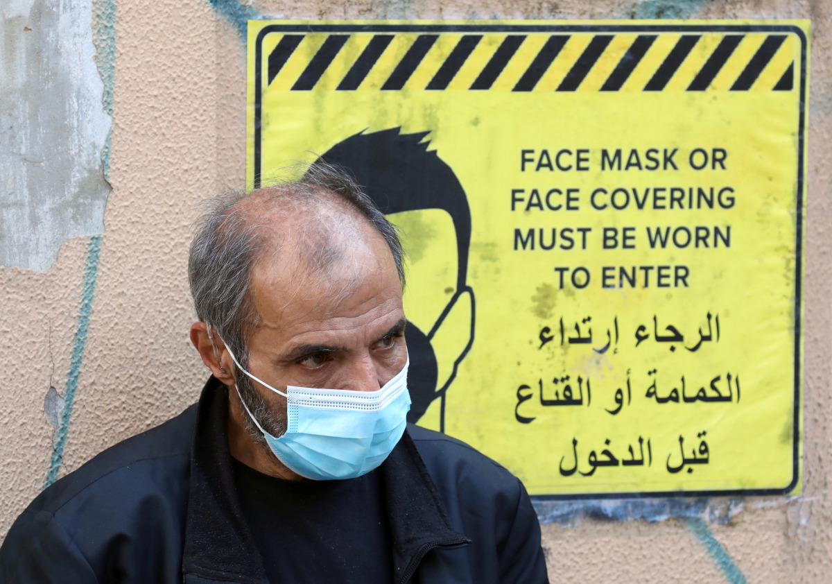 A man wearing a protective face mask waits to get tested for the coronavirus disease (COVID-19), in Beirut, Lebanon January 4, 2021. Picture taken January 4, 2021. REUTERS/Mohamed Azakir
