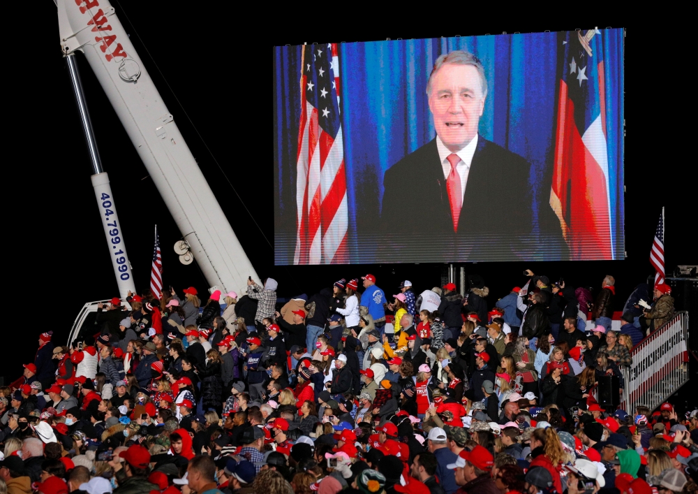 Republican US Senator David Perdue appears in a video as US President Donald Trump campaigns with Republican US Senator Kelly Loeffler on the eve of Georgia's run-off election in Dalton, Georgia, US, January 4, 2021. Reuters/Brian Snyder