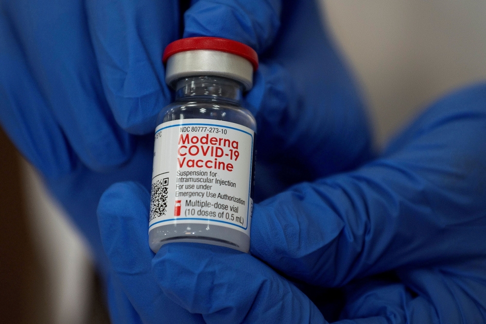 FILE PHOTO: An employee shows the Moderna coronavirus disease (COVID-19) vaccine at Northwell Health's Long Island Jewish Valley Stream hospital in New York, U.S., December 21, 2020. REUTERS/Eduardo Munoz