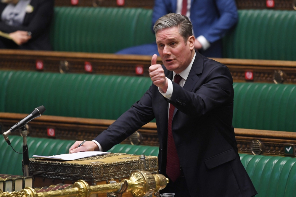 A handout photograph released by the UK Parliament shows Britain's main opposition Labour Party leader Keir Starmer gesturing as he replies to the opening remarks from Britain's Prime Minister Boris Johnson during the debate on the second reading of the E