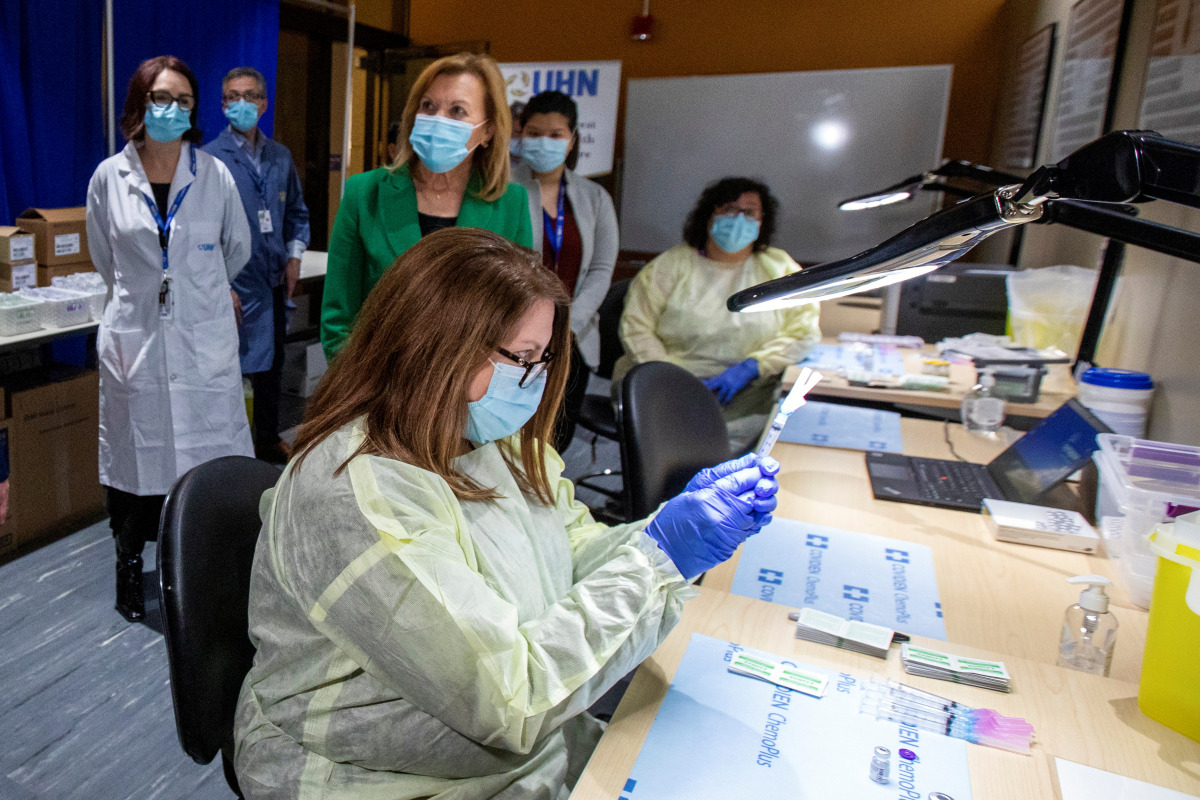Pharmacy technician supervisor Tamara Booth Rumsey prepares a Pfizer-BioNTech coronavirus disease (COVID-19) vaccine at The Michener Institute, in Toronto, Canada January 4, 2021. REUTERS/Carlos Osorio
