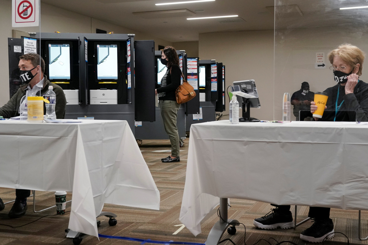 A voter casts her ballot in Georgia’s Senate runoff elections on an electronic voting machine at a Fulton County polling station in Sandy Springs, Georgia, U.S. January 5, 2021. REUTERS/Elijah Nouvelage
