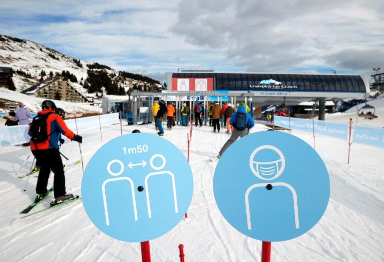 Skiers pass the restriction signs to line up at the chairlift at Les Portes du Soleil ski resort during the global outbreak of the coronavirus disease (COVID-19), in Les Crosets, Switzerland, December 19, 2020. REUTERS/Denis Balibouse/File Photo