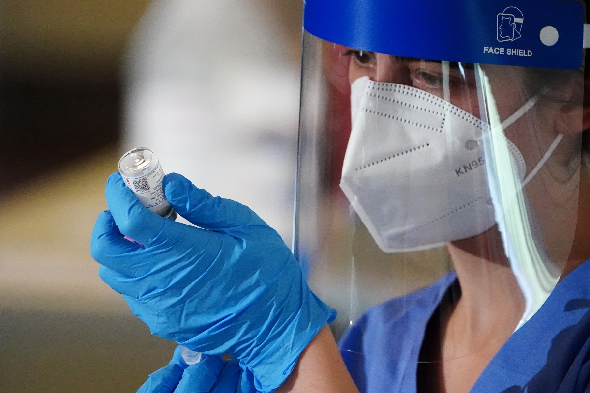 FILE PHOTO: A nurse prepares a syringe with the COVID-19 vaccine for a worker of the New York City Fire Department Bureau of Emergency Medical Services (FDNY EMS), amid the coronavirus disease (COVID-19) pandemic in the Manhattan borough of New York City,