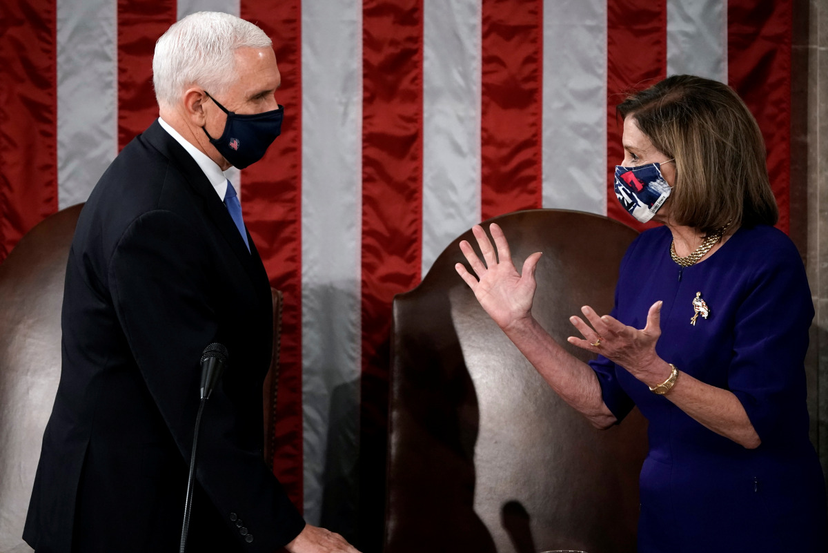 Speaker of the House Nancy Pelosi (D-CA) and Vice President Mike Pence talk before a joint session to certify the 2020 election results, at the Capitol in Washington, U.S., January 6, 2021. J. Scott Applewhite/Pool via REUTERS
