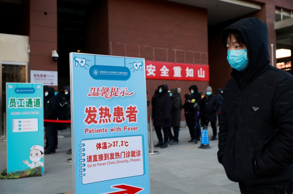 People line up to get a nucleic acid test at a hospital following an outbreak of the coronavirus disease (COVID-19) in Beijing, China January 7, 2021. REUTERS/Thomas Peter