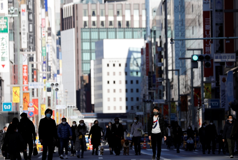 Pedestrians wearing protective masks, amid the coronavirus disease (COVID-19) outbreak, make their way at Ginza shopping district which closed to cars on Sunday in Tokyo, Japan, January 10, 2021. REUTERS/Kim Kyung-Hoon