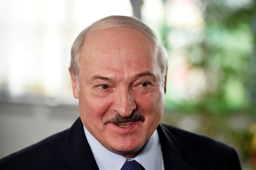 FILE PHOTO: Belarusian President Alexander Lukashenko visits a polling station during the presidential election in Minsk, Belarus August 9, 2020. Sergei Gapon/Pool via REUTERS